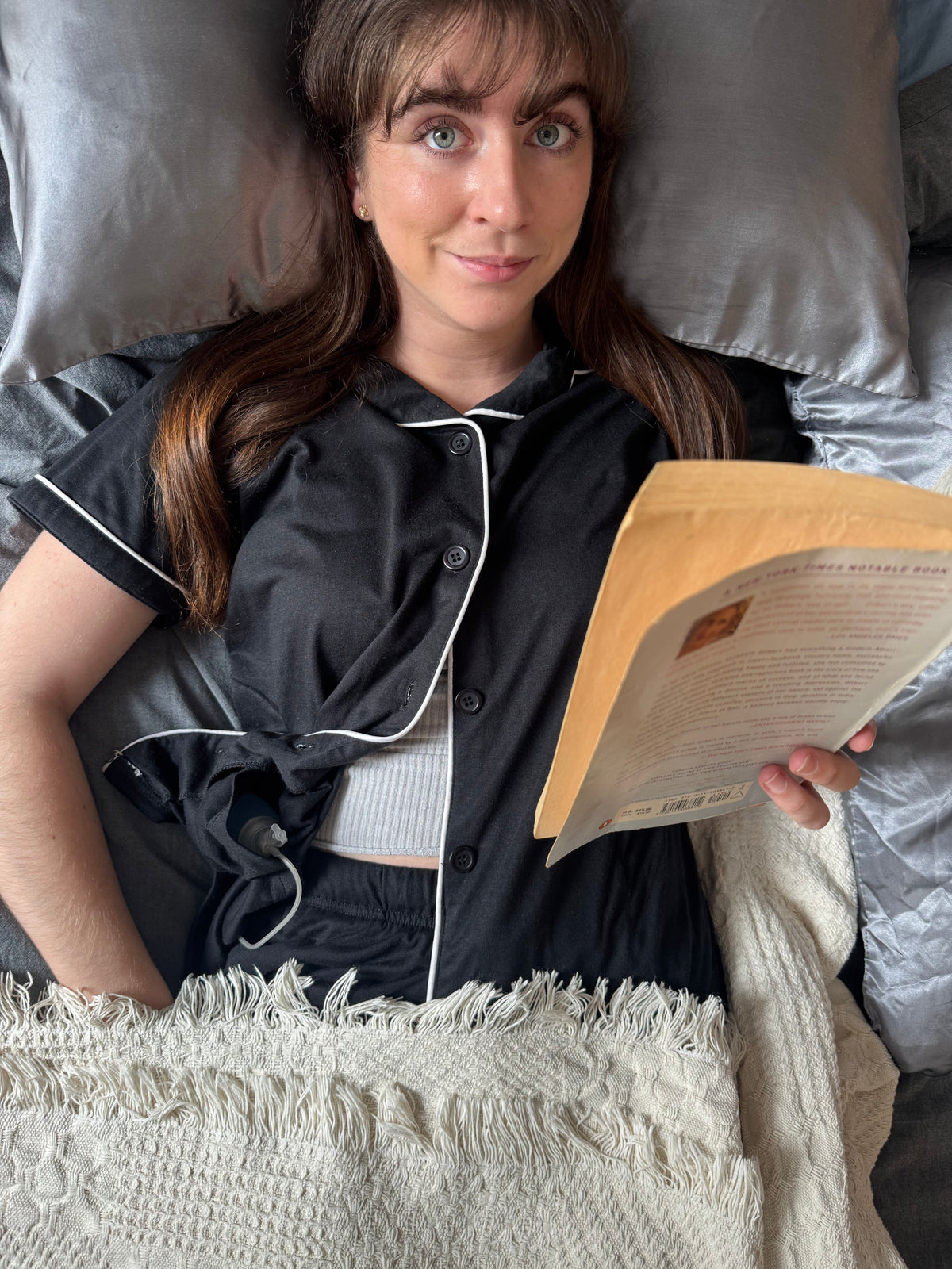 Woman wearing an Inspired Comforts mastectomy recovery top with internal drain pockets, at ease during recovery